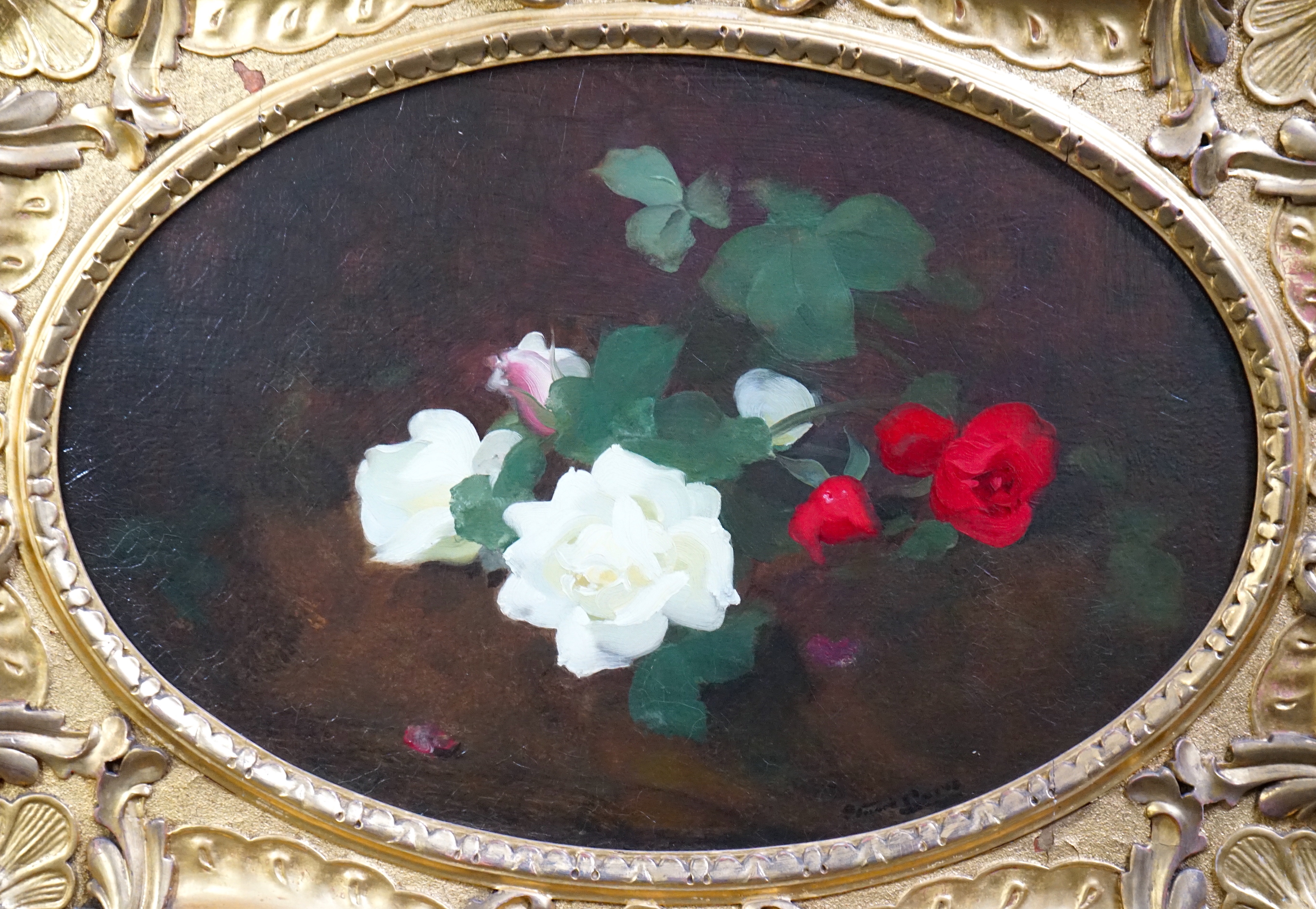 Stuart Park (Scottish, 1862-1933), Red and white roses upon a ledge, oil on canvas, oval, 50 x 75cm, in ornate giltwood frame